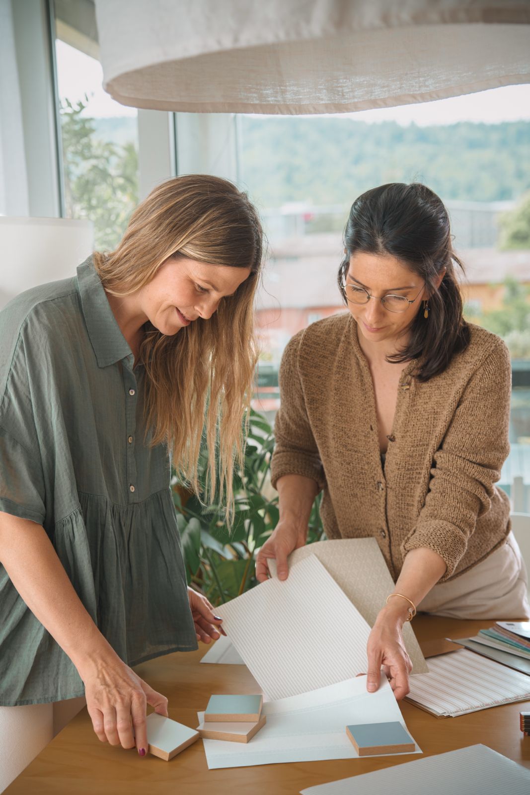 Paola Casacuberta and Andrea Zupan-Dover, founders of 2am Studio, working at their studio desk in Zurich